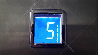 Elevator floor display panel showing descent movement