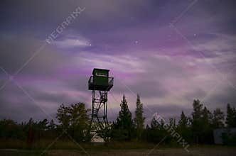 Lonely watch tower with Big Dipper and Aurora