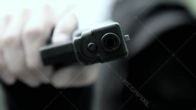A bandit or robber, a criminal element pointed a gun at someone and demands they give up their wallet or threaten to