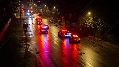Emergency Response: Police Convoy Responding to Incident at Night with Flashing Lights and