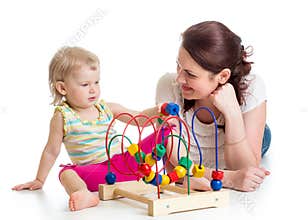 Child girl and mother play with color educational toy