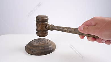 A man bangs a wooden gavel. Video with sound.