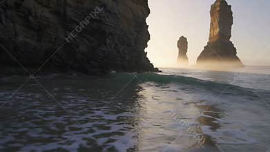 Gentle waves lapping on the shore at sunrise near twelve apostles, australia
