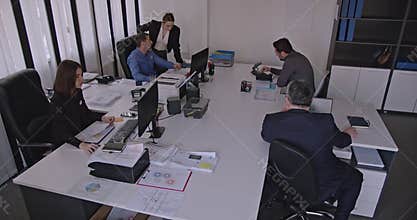 Business Colleagues Collaborating and Analyzing Data in a Modern Office