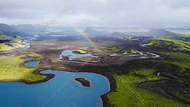 Aerial sweep of Icelandic highlands with rivers and meltwater lakes