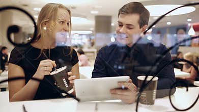 Colleagues in cafe during break drinking coffee