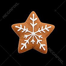 A Star-Shaped Gingerbread Cookie Features Intricate White Icing Designs Resembling Snowflakes