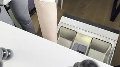 loading dirty utensils and cutlery into an open dishwasher in