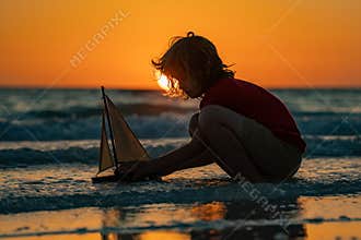 Child playing with a toy boat. Little kid boy sailing toy ship on sea water. Summer vacation with kids. Kid dreaming about sailing