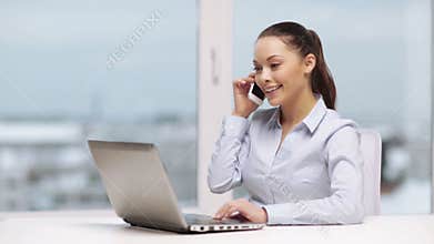 Businesswoman with smartphone in office