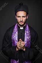 Humble priest with Christian Cross