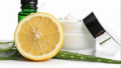 Fresh Lemon and Aloe Vera with Skincare Products on White Background