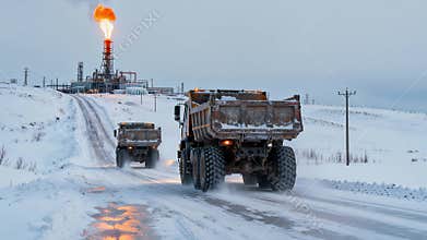 Convoy Of Heavy Vehicles On Icy Roads Supporting Oilfield Operations