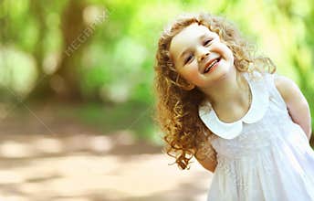 Cute baby girl shone with happiness, curly hair