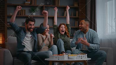 Happy four multiethnic friends supporting television sport team win champions applauding cheering men women at home