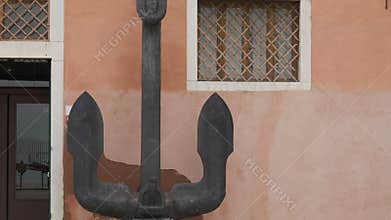 Large iron anchor displayed outside Naval History Museum in Venice