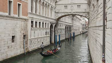 Gondola with gondolier passing under the Bridge of Sighs in Venice Italy