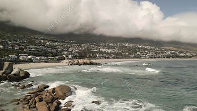Dramatic View of Camps Bay Beach with Cloudy Mountains