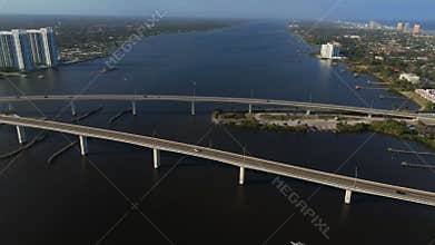 Aerial view of wide river corridor with twin bridges near Daytona Beach