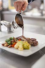 Chef plating up food in a restaurant