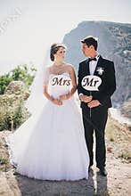 Bride and groom with Mr and Mrs signs