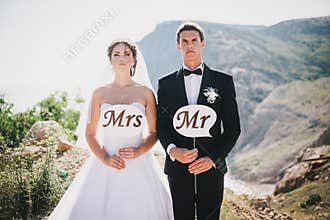 Bride and groom with Mr and Mrs signs