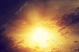 Vintage image of sunset sky with dark dramatic clouds. Background