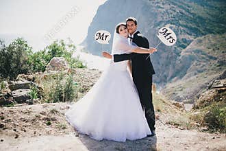 Bride and groom with Mr and Mrs signs
