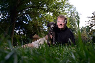 Selfie of Man holding Pet Dog