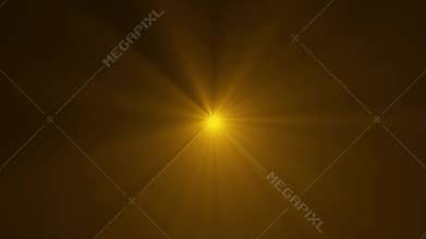 Golden starburst light on dark background
