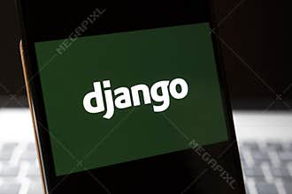 Warsaw, Poland - Feb 24, 2026: A close-up of a smartphone displaying the logo of Django on a green background, symbolizi