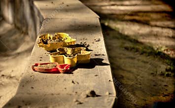 Colorful Sand Molds with Dirt in Warm Sunlight