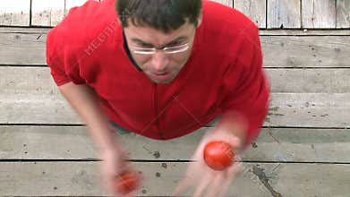 Man juggling with tomatoes