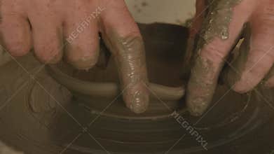 Potter Shaping Edges of Handmade Clay Plate with Fingers