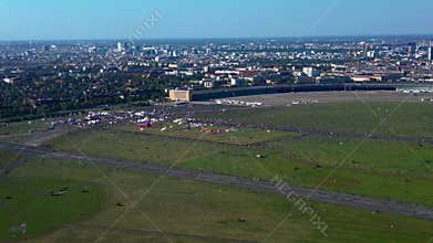 Berlin Tempelhofer Feld giant kite festival. Smooth aerial view flight drone