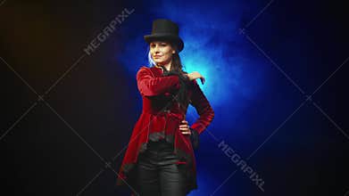 happy woman fashion model posing in black studio adjusting brim of top hat. fog dark city street night. Adult girl