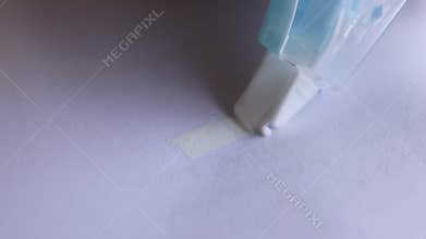 Correction tape covering blue pen marks on paper, representing editing, fixing mistakes, and document accuracy