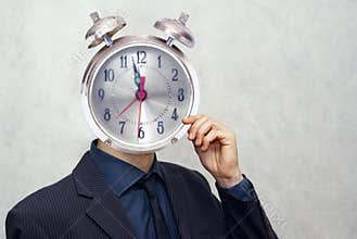 Businessman with alarm clock head
