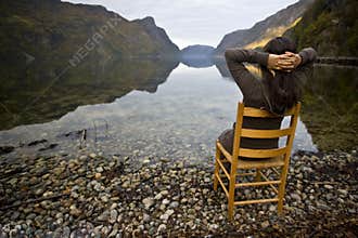 Woman in chair near lake shores