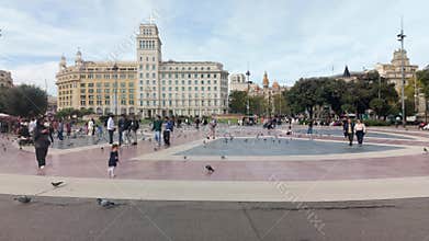 Barcelona, Spain. November 1, 2025: People and pigeons walking in Placa de Catalunya in Barcelona