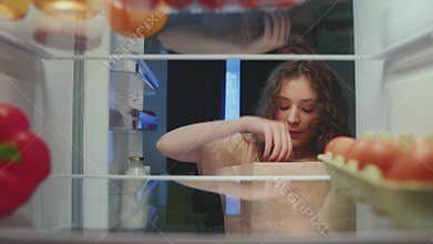 Young Woman Opening Fridge Door and Putting Fresh Healthy Food of Bag on Shelves