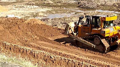 Moscow, Russia - May 19, 2025: Caterpillar bulldozer is actively grading soil