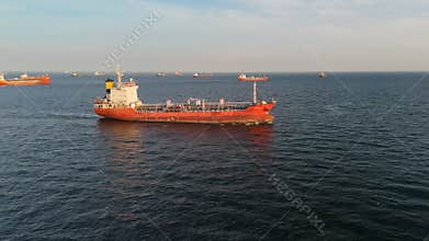 Red Cargo Ship Sailing on Open Sea Amidst Busy Shipping Lanes