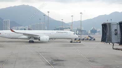 airside view in HKG Hongkong Airport while ground service staffs doing ground service operation push back Philippines airline