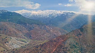 Ancient Sierra Nevada highlands of Andalusia with snow covered peaks red earth valleys traces of moorish heritage routes
