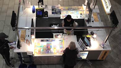 Top shot of people buying lottery ticket