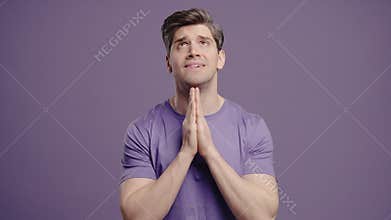 Mature Man with Hands in Prayer Begging, Hoping for Something in Silence, Violet