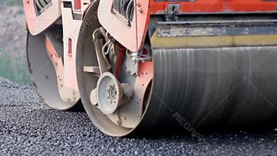 Asphalt roller working on the street that was recently repaired