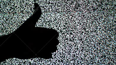 Thumb down and thumb up for like and dislike or Approval and disapproval concept against static TV noise background