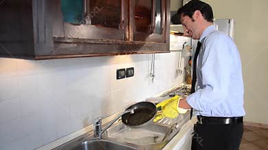 Businessman washing dishes